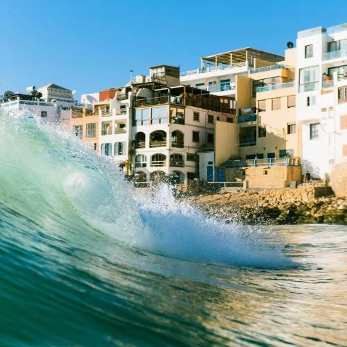 Wave breaking in front of the houses of Taghazout village