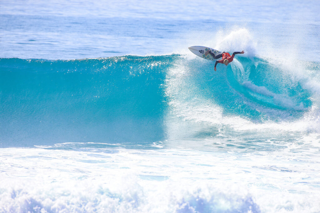 Surfer catching waves at a surf camp in Taghazout, Morocco