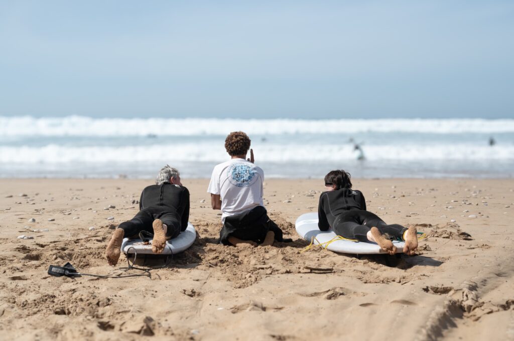 Beginner and intermediate surfers enjoying surf lessons in Taghazout.