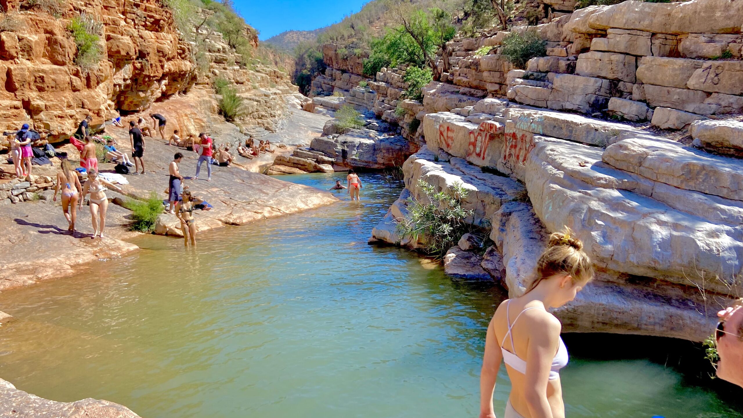 Tourists swimming in the turquoise waters of Paradise Valley near Agadir