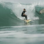 Surfer riding a wave in Taghazout under perfect surf conditions.