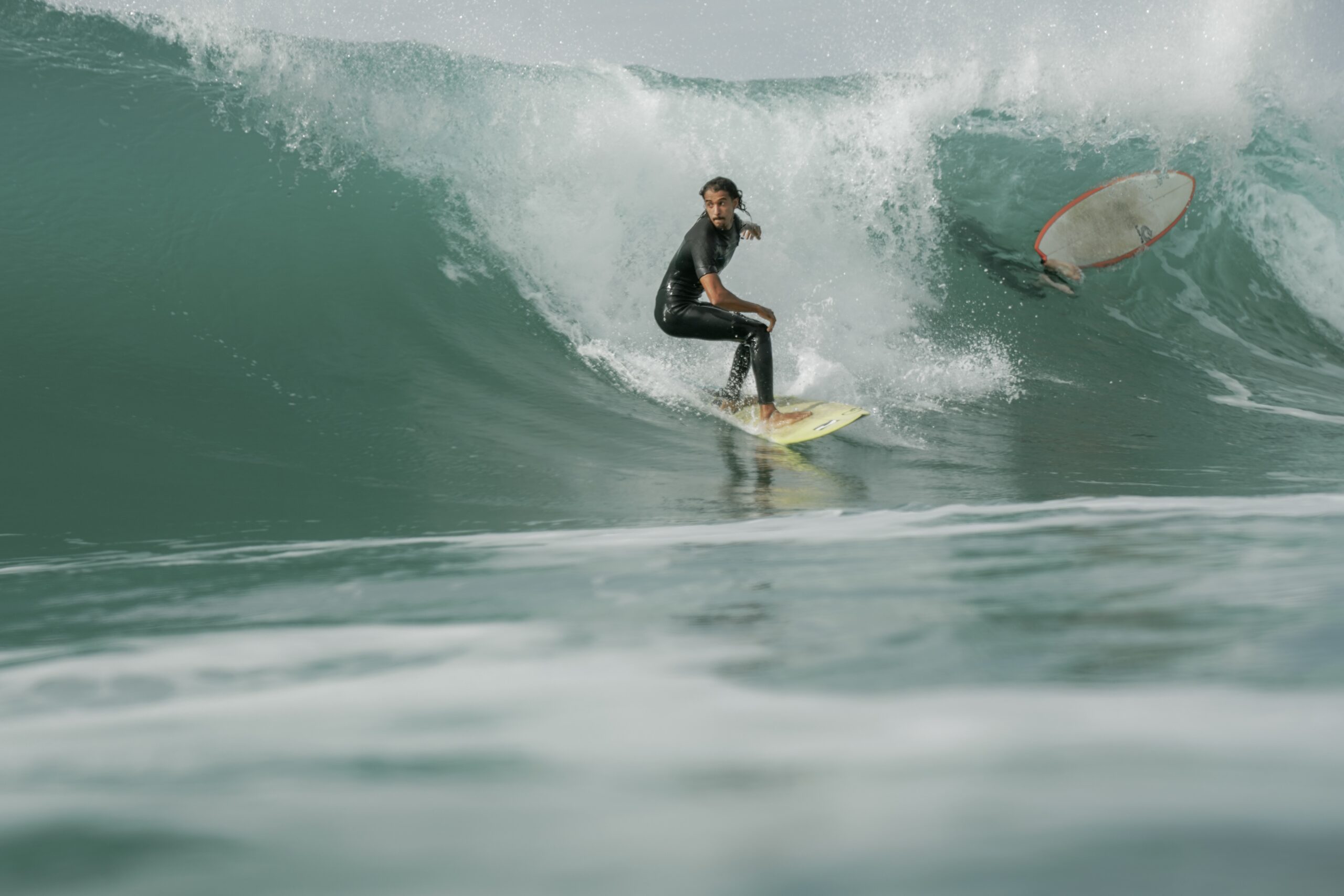 Surfer riding a wave in Taghazout under perfect surf conditions.