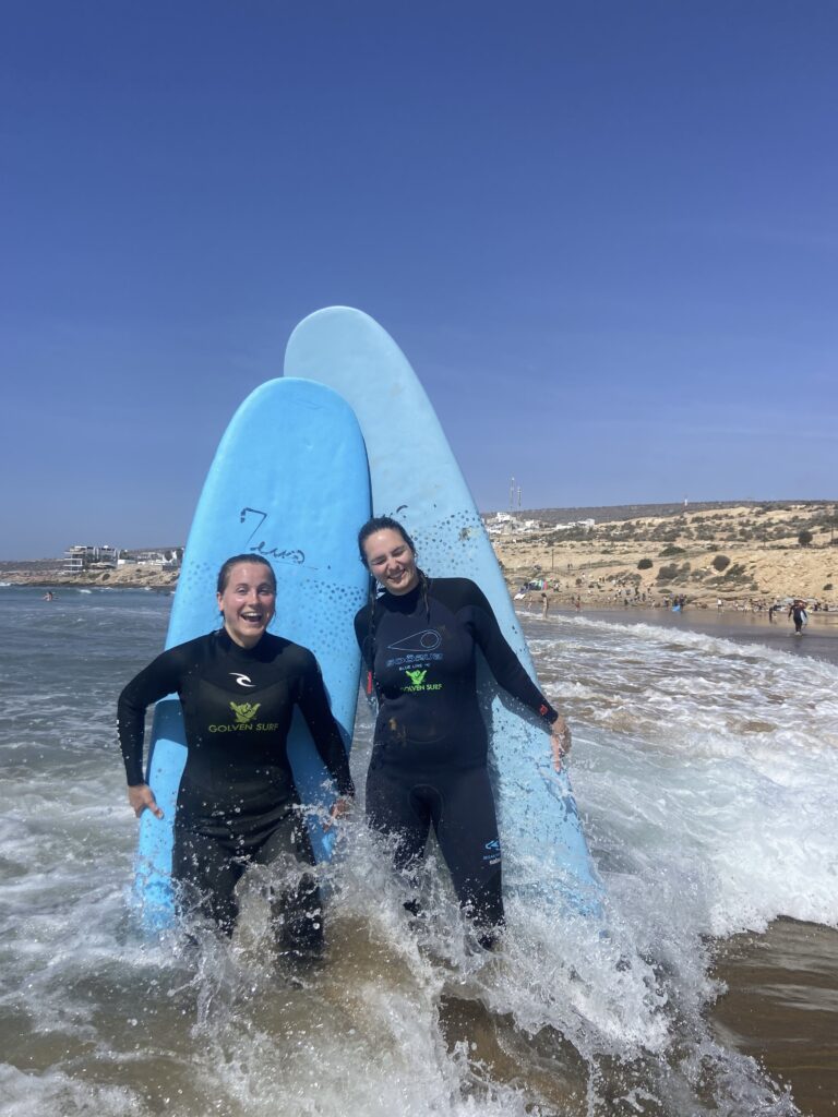 Beginner surfer at Surf Camp Taghazout Morocco catching their first wave