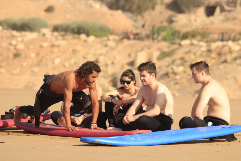 Group of surfers enjoying the vibrant surf culture in Taghazout.