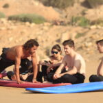 Group of surfers enjoying the vibrant surf culture in Taghazout.