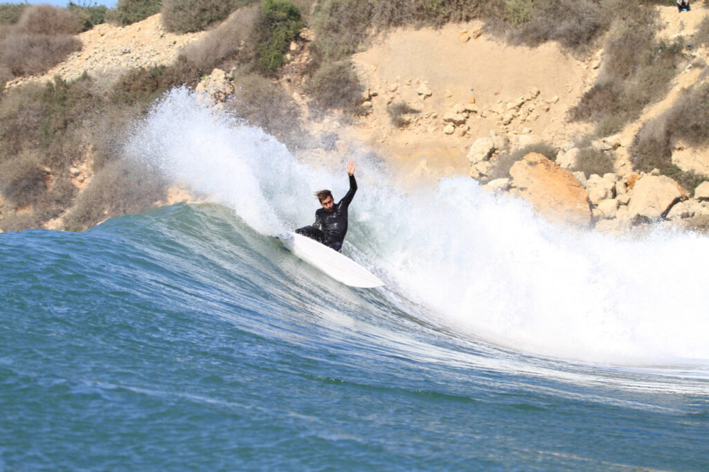 Surfer riding a perfect wave at Anchor Point, Taghazout