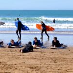 Surf instructor guiding a group at a Taghazout surf camp