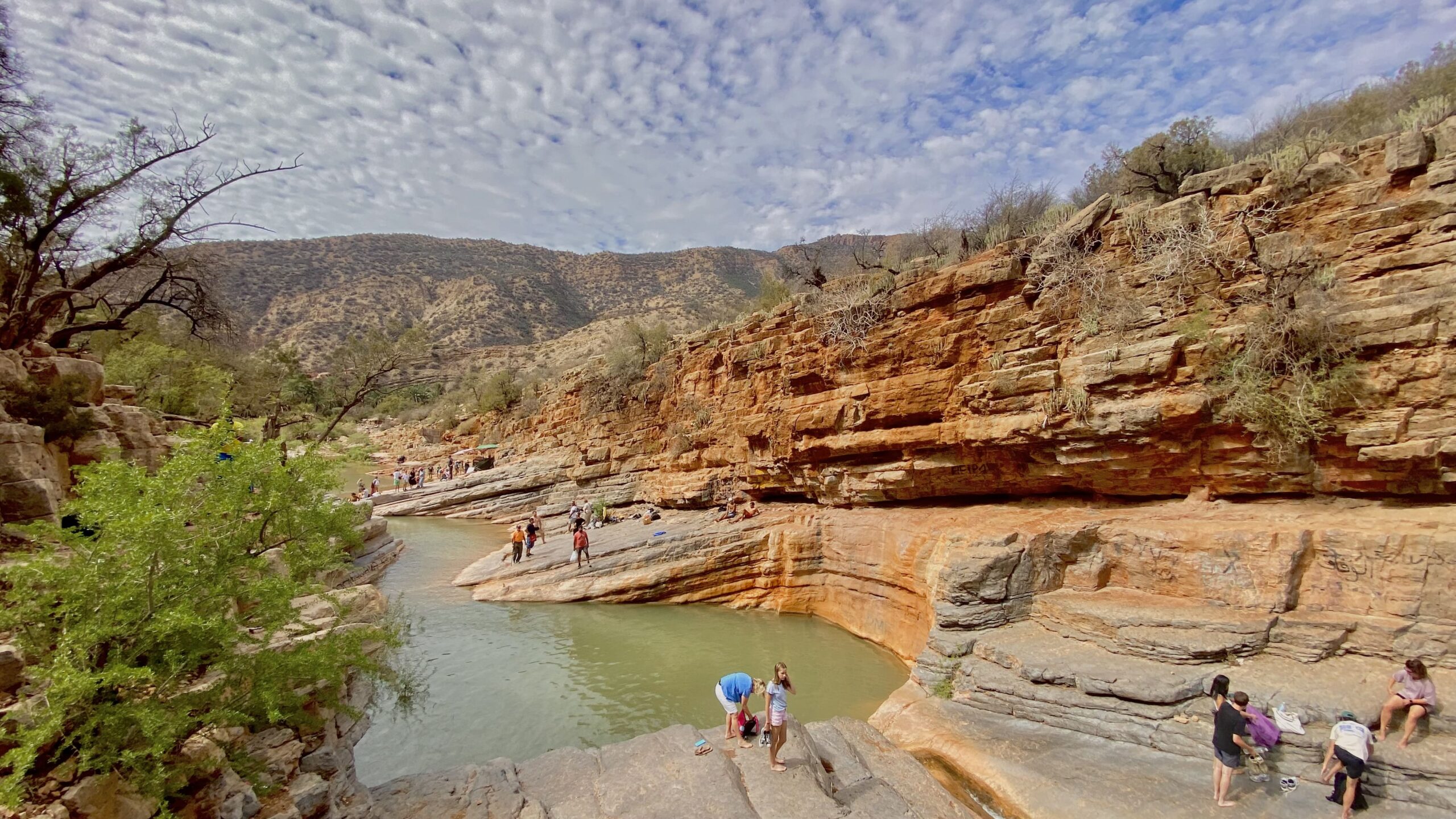 Visitors relaxing by the fresh water pools in Paradise Valley Morocco