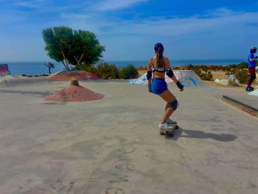 Learning skateboarding techniques during a skate lesson in Taghazout, Morocco, at a surf camp.