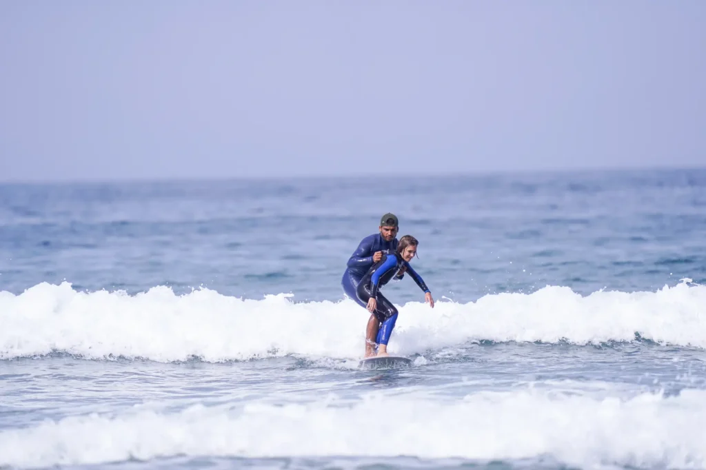 Beginner surfers learning at a surf camp Taghazout.