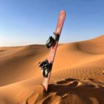 Snowboard resting on the sand at Timlalin Dunes ready for sandboarding