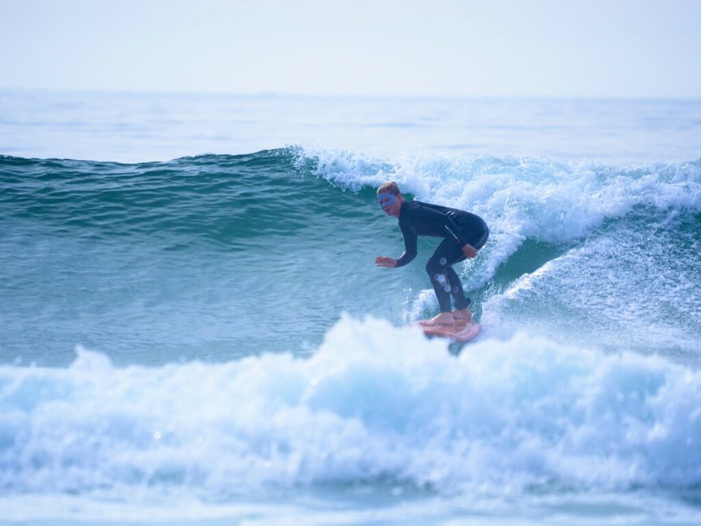 a person on a s urfboard riding a wave