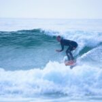 a person on a s urfboard riding a wave