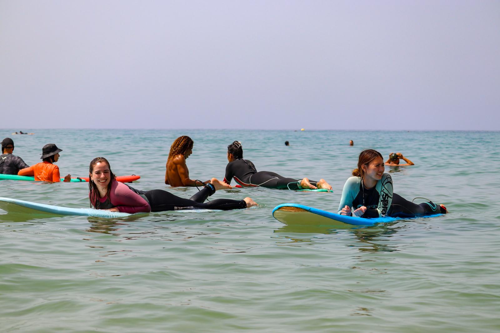 Two beginner girls learning to surf at a beach near surf camp Taghazout