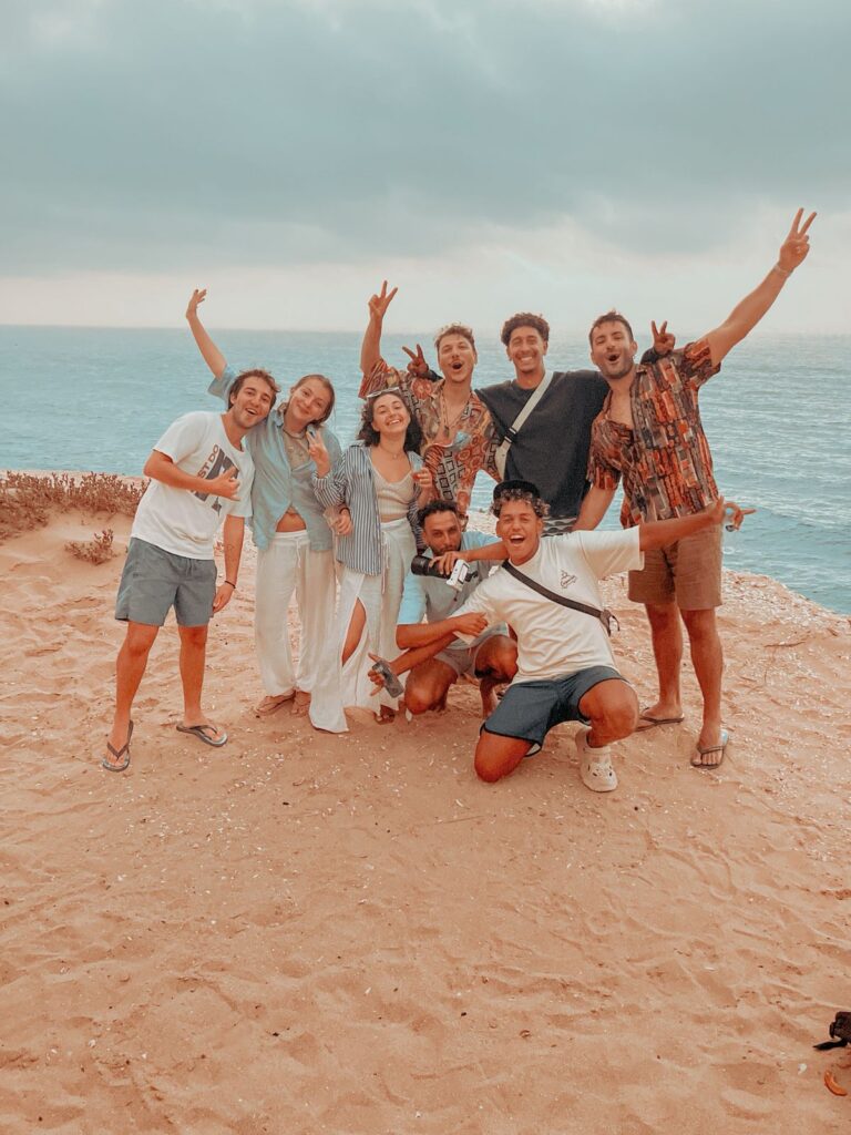 Group enjoying sunset after sandboarding taghazout near Atlantic coast