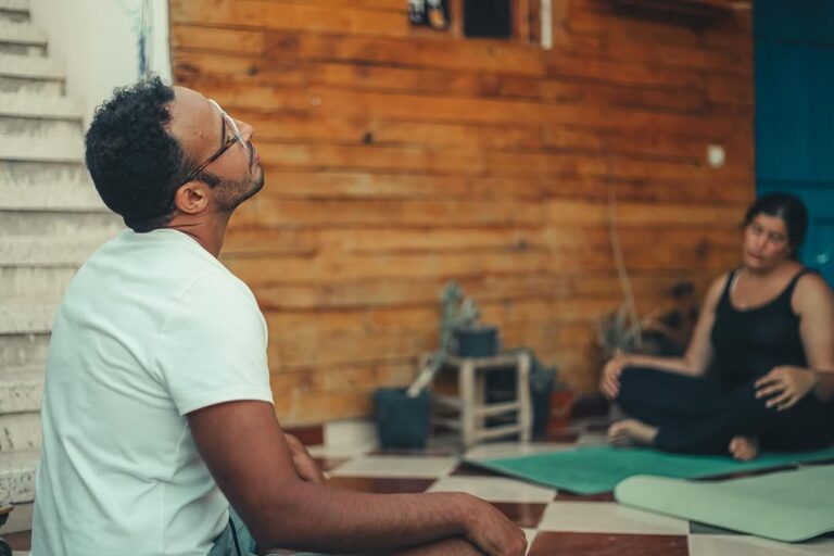 Yoga session on rooftop terrace overlooking Taghazout beach during 6 Day Surf Yoga Sahara Adventure