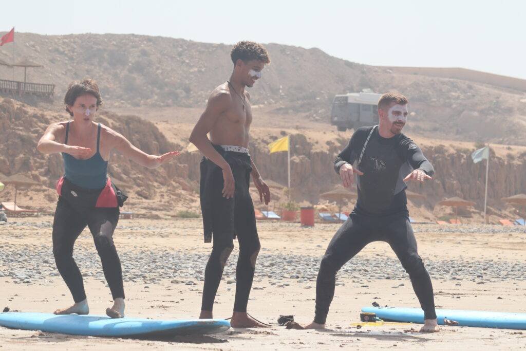 Surf instructor teaching technique during free surf lesson Taghazout collaboration program