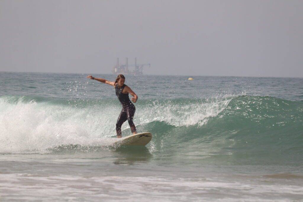 Happy surfer standing up during a 2 hours surf lesson in Taghazout