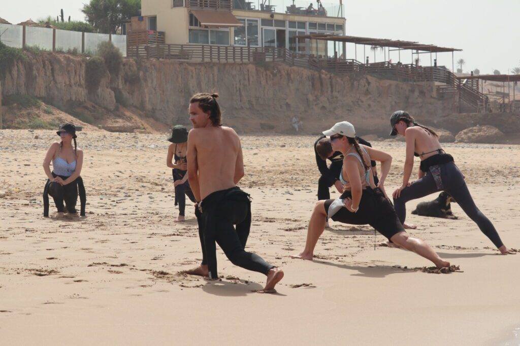 Surf instructor explaining surfing basics on the beach during a 2 hours surf lesson in Taghazout