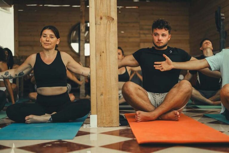 Yoga session on rooftop terrace overlooking Taghazout beach during 4 Day Surf Yoga Sahara Quad Adventure