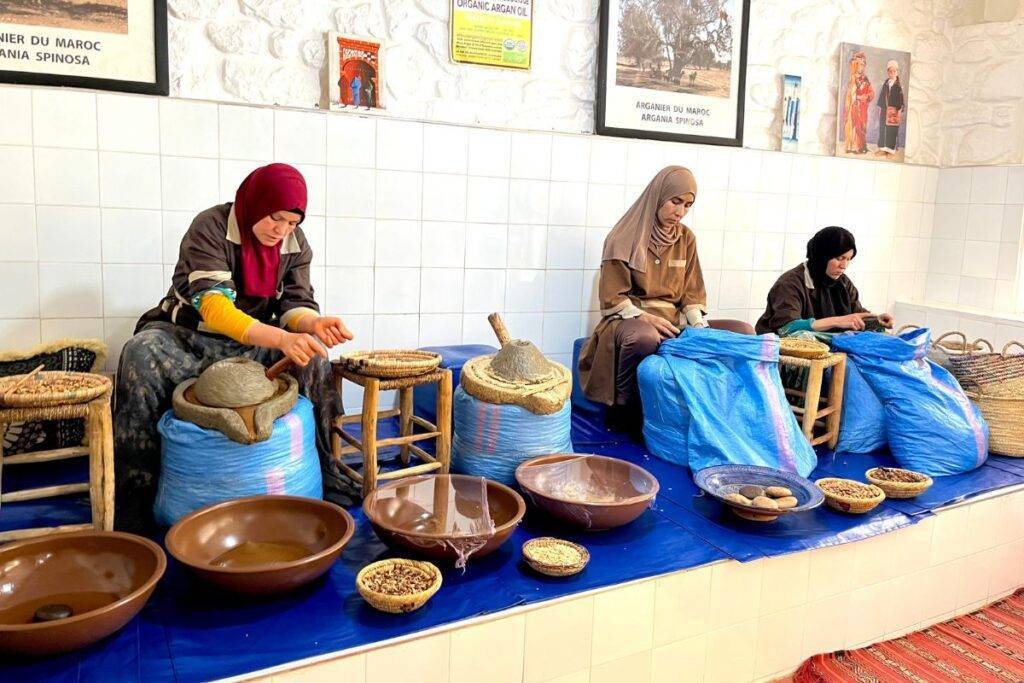 Moroccan women working at an argan oil cooperative demonstrating traditional production methods